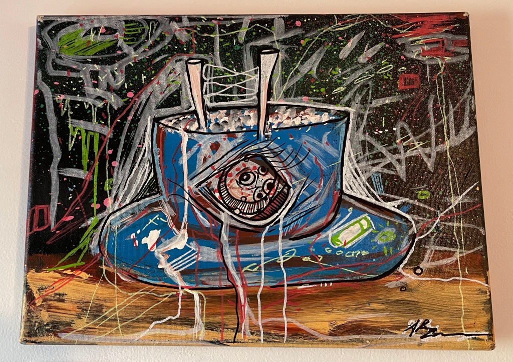 Alternately titled "Cosmic Rice Bowl," this painting depicts a blue rice bowl with eyes peering out of it along with eyelashes. A brown tabletop and black background with graffiti in several colors complete the image